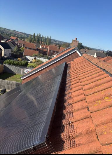 Solar panel Protection In Somerset Close-up of a rooftop with solar panels and a clear blue sky above.