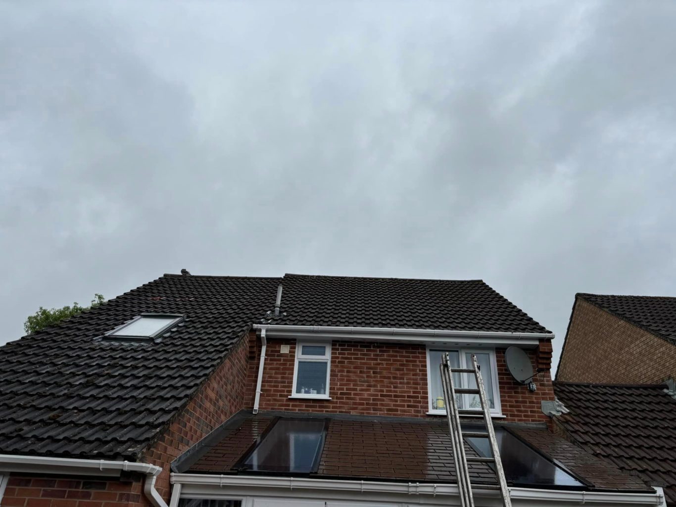 Roof Cleaning View of a building's roof under a cloudy sky.