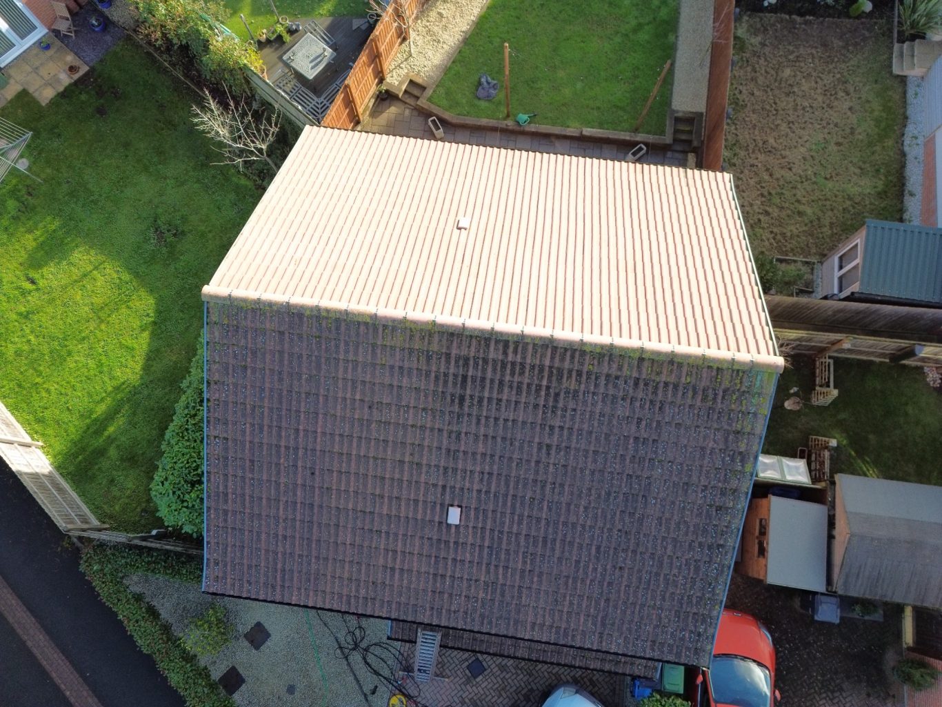 Low pressure wash and biocide treatment in Wellington Aerial view of a house with a sloped roof and surrounding greenery.