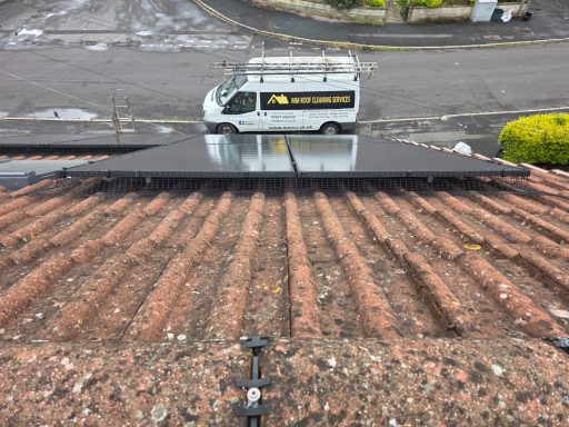 Solar panel Protection In Bristol Solar panels on a rooftop overlooking a service van and a residential street.
